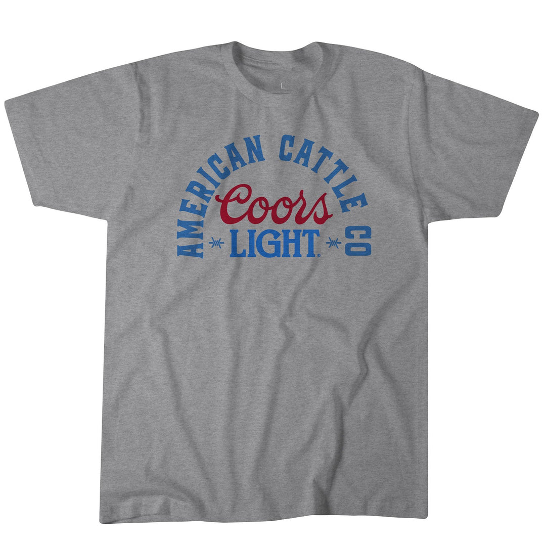 The American Cattle Co ACC Coors Light Lockup Tee is a gray poly-cotton blend shirt featuring "American Cattle Co" in blue and "Coors Light" in red and blue on the front with an arched, stylized font.