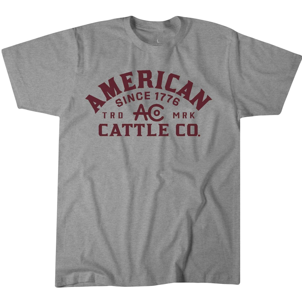 The ACC Mark Tee by Rural Cloth features soft combed ring spun cotton in Light Heather Gray, a rib knit neck, and maroon collegiate-style "AMERICAN CATTLE CO. SINCE 1776 TRD MRK AC" text on the front.