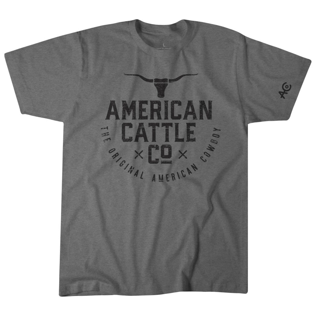 The American Cattle Co American Cowboy Tee is a gray premium-weight shirt with a longhorn skull and "American Cattle Co The Original American Cowboy" graphic, plus a small logo on the left sleeve.