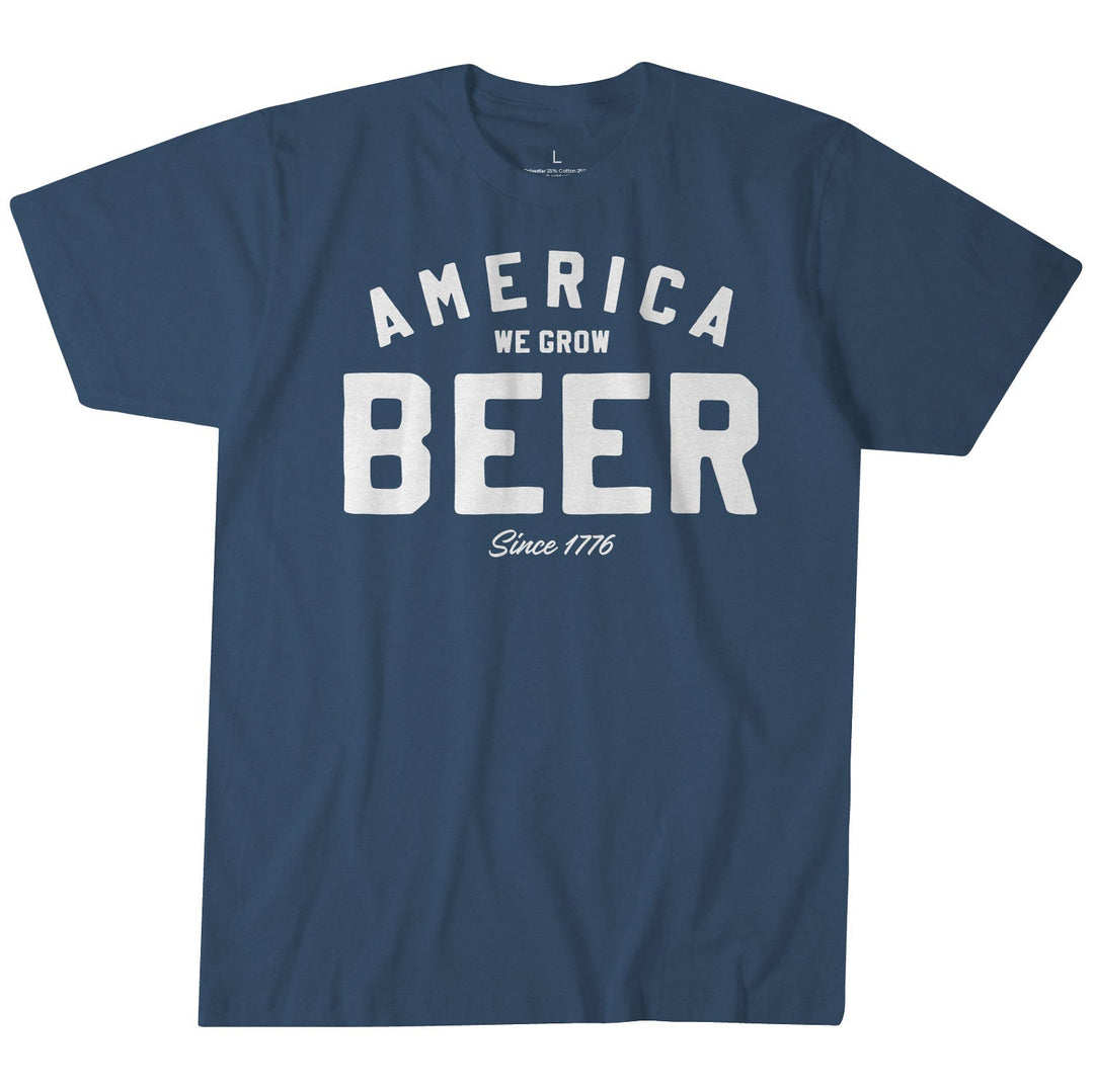 The Rural Cloth Beer Tee is a blue shirt with white text: "America We Grow Beer Since 1776." Proudly made in the USA—perfect for celebrating your rural American roots.
