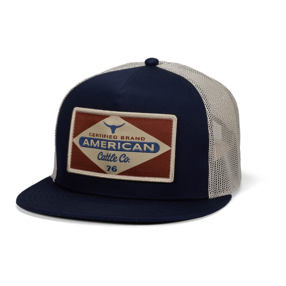 The Billboard Hat-Flat by Rural Cloth is a navy blue and white mesh rancher with a flat brim, featuring a front patch reading "American Cattle Co. 76" and bull graphics—a certified classic from the brand.
