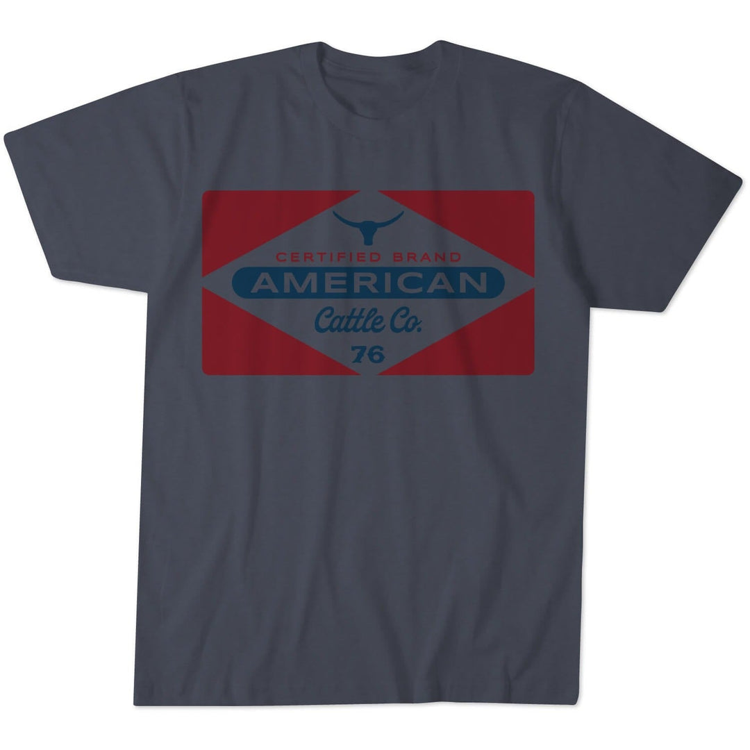 A heather navy "Billboard Tee" by Rural Cloth, featuring a red and navy rectangular graphic that reads "Certified Brand American Cattle Co. 76" with a bull head icon at the top center—ideal for anyone seeking an authentic rancher shirt style.