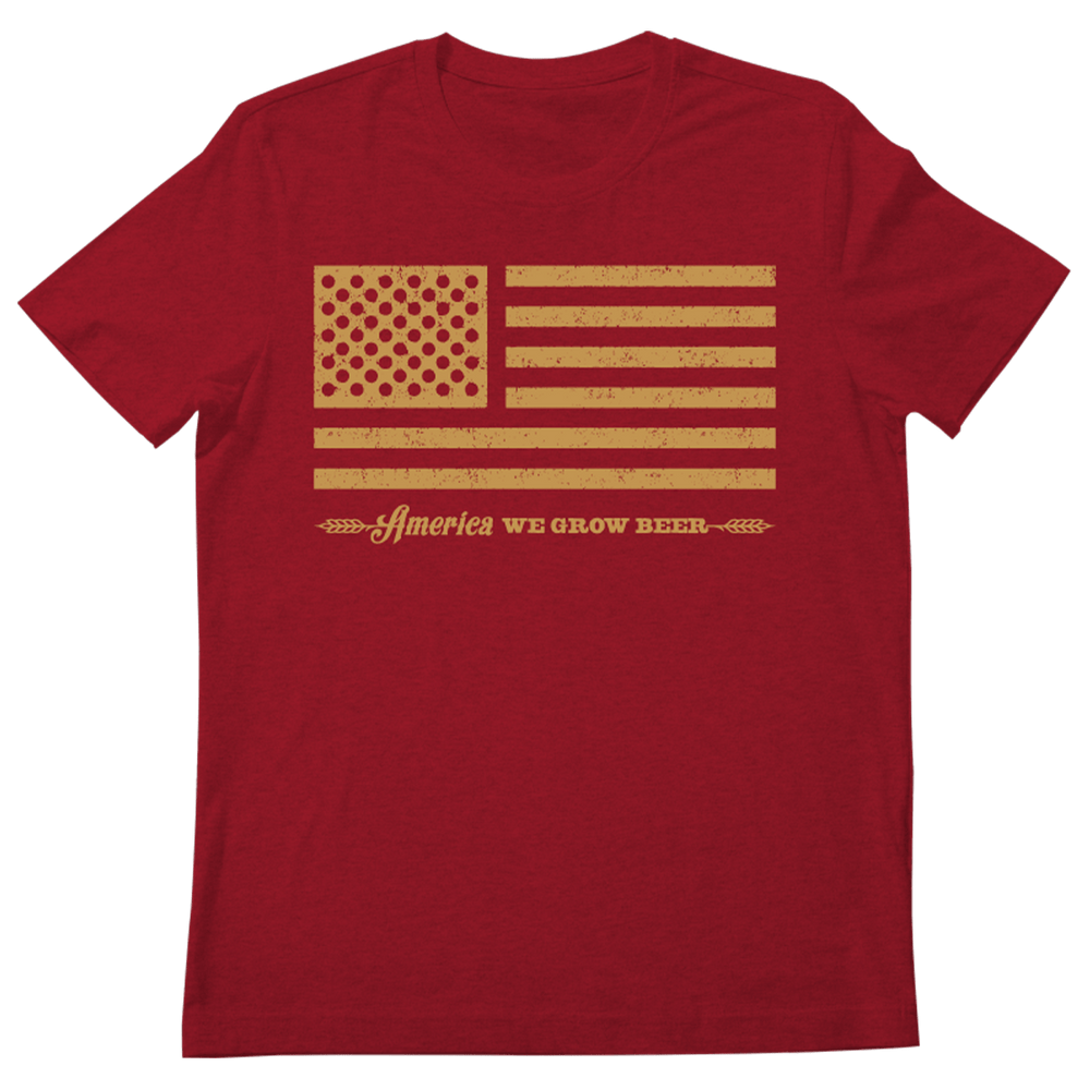 Show your love for American beer culture with the Rural Cloth Bottle Cap Tee—a red shirt featuring a yellow barley flag and “America We Grow Beer” underneath. Perfect patriotic style for beer fans!.