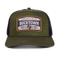 Front view of the Bucktown Outrider Hat by Rural Cloth, an olive green trucker with mesh back. The front patch shows a steer head, 