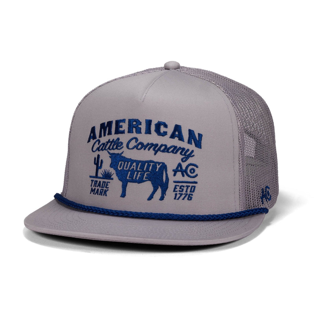The Bull Crest Hat by American Cattle Co is a gray mesh high crown snapback with "American Cattle Co." and a blue cow graphic embroidered on the front, extra detailing, and a stylish blue rope accent on the brim.