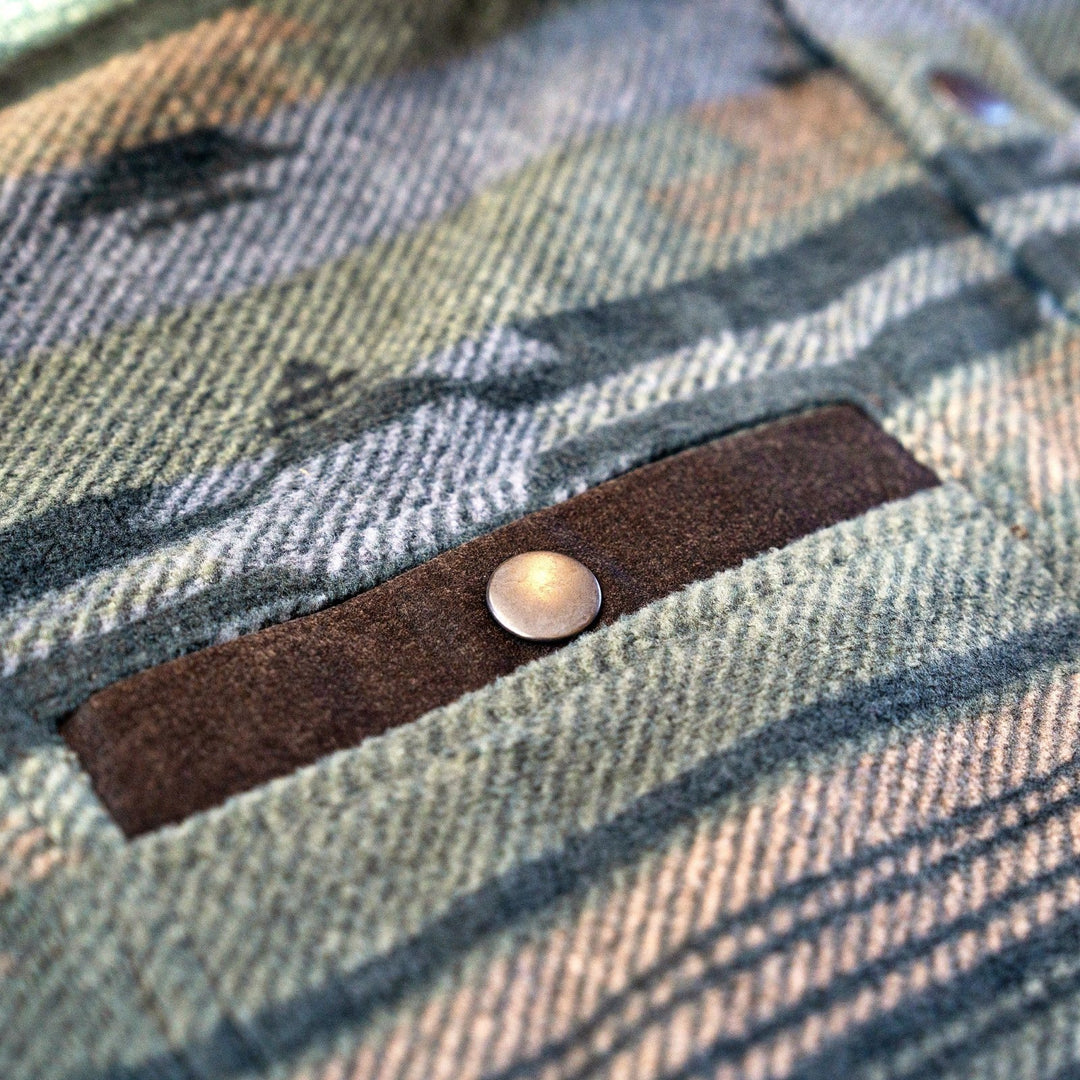 Suede-trimmed chest pocket with snap on the Desperado Polar Fleece in Olive, showing the geometric pattern.