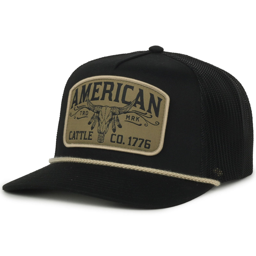 The American Cattle Co Headdress Hat in black features a beige patch with a longhorn skull, "American Cattle Co. 1776" text, and a beige rope across the brim—ideal for showcasing classic American grit.