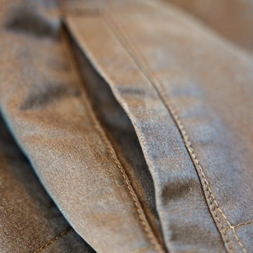 Close-up of the welt hand pocket and contrast topstitching on the Homestead Jacket in Buck.