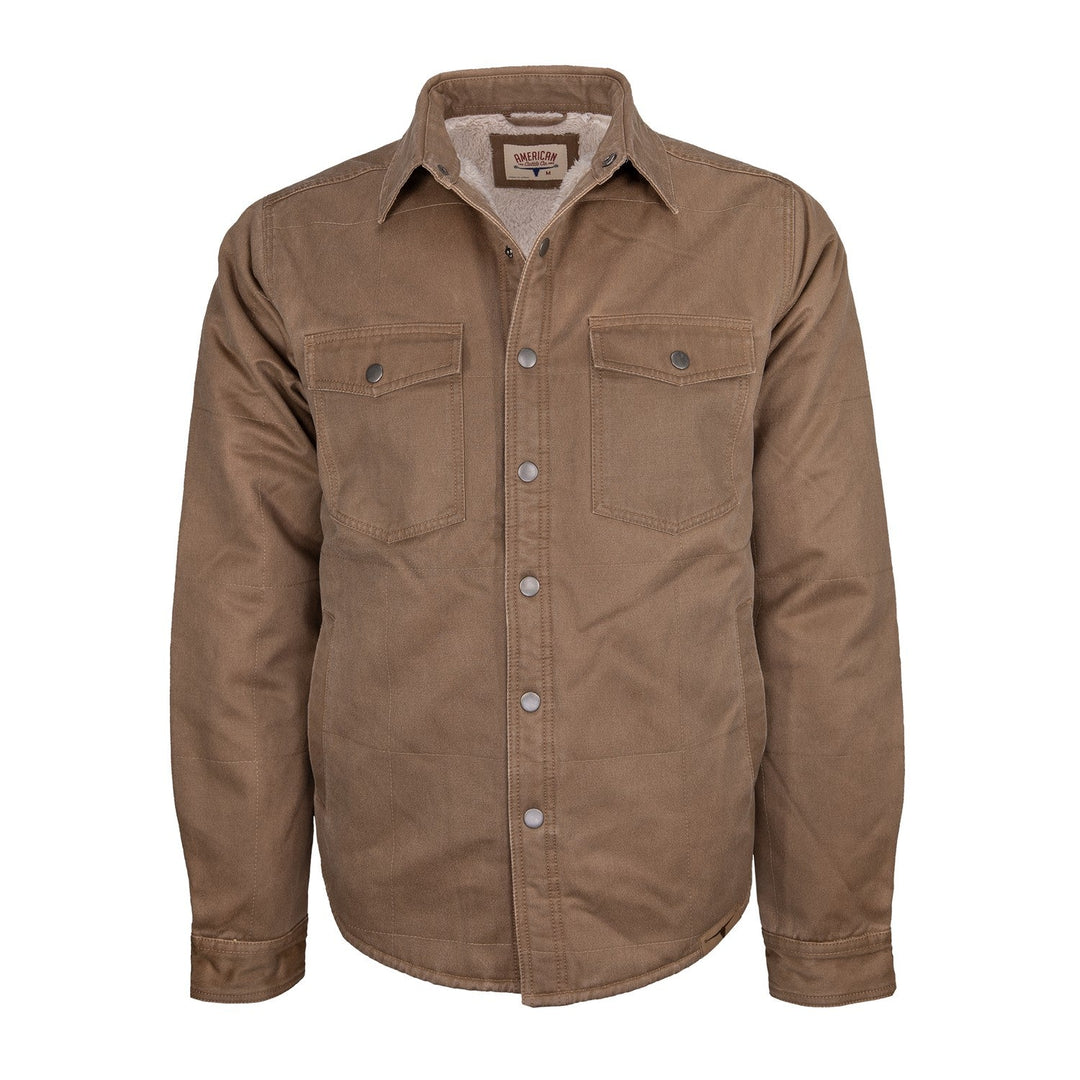 The American Cattle Co Homestead Jacket in Buck is a brown button-up jacket featuring two front chest pockets and a collar, displayed against a white background. This ultrasuede jacket boasts a sturdy, canvas-like material, making it ideal for both work and casual wear.