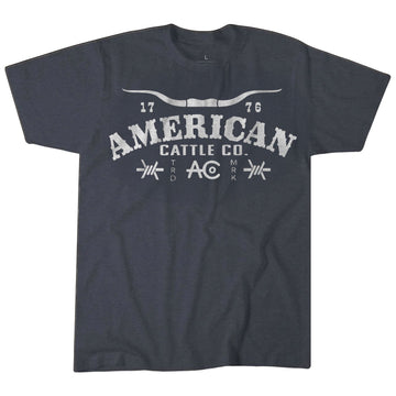 The American Cattle Co Longhorn Barb Tee in heather blue is crafted from a soft poly-cotton blend and features "AMERICAN CATTLE CO." in distressed white, flanked by "17" and "76," with a steer horn graphic—a classic Western-inspired tee.
