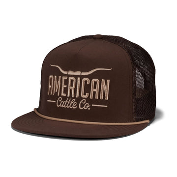 The Rural Cloth Longhorn Hat features a brown mesh, flat brim, tan piping on the visor, and a 5-panel snapback design. "AMERICAN Cattle Co." embroidery with a cattle horn graphic highlights your ranching lifestyle.