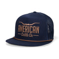 Here’s a rewritten version of the sentence using your product data: The Rural Cloth Longhorn Hat is a navy mesh 5-panel snapback trucker hat featuring “American Cattle Co.” and a longhorn graphic embroidered in tan on the front. Designed for those who embrace the ranching lifestyle, this hat features a flat bill with a tan accent along the edge and an adjustable mesh back.