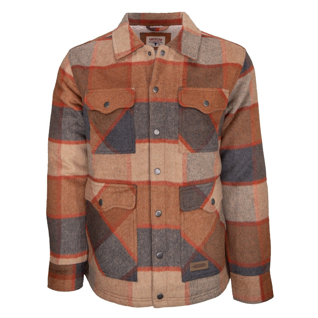 The Lumberjacket is a men’s chore jacket crafted from plaid wool in shades of brown, tan, gray, and orange. It features two chest pockets, two lower front pockets, a collar, a small fabric brand tag above the left pocket, and is fully lined with sherpa for extra warmth and comfort.