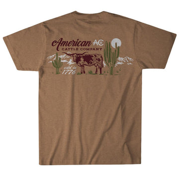 Back of a gold heather On the Range Tee by American Cattle Co, featuring a cow, cacti, and sun or moon graphic. Text: "American Cattle Company," "estd. 1776," and "AC." Classic Southwest style. Poly-cotton blend.