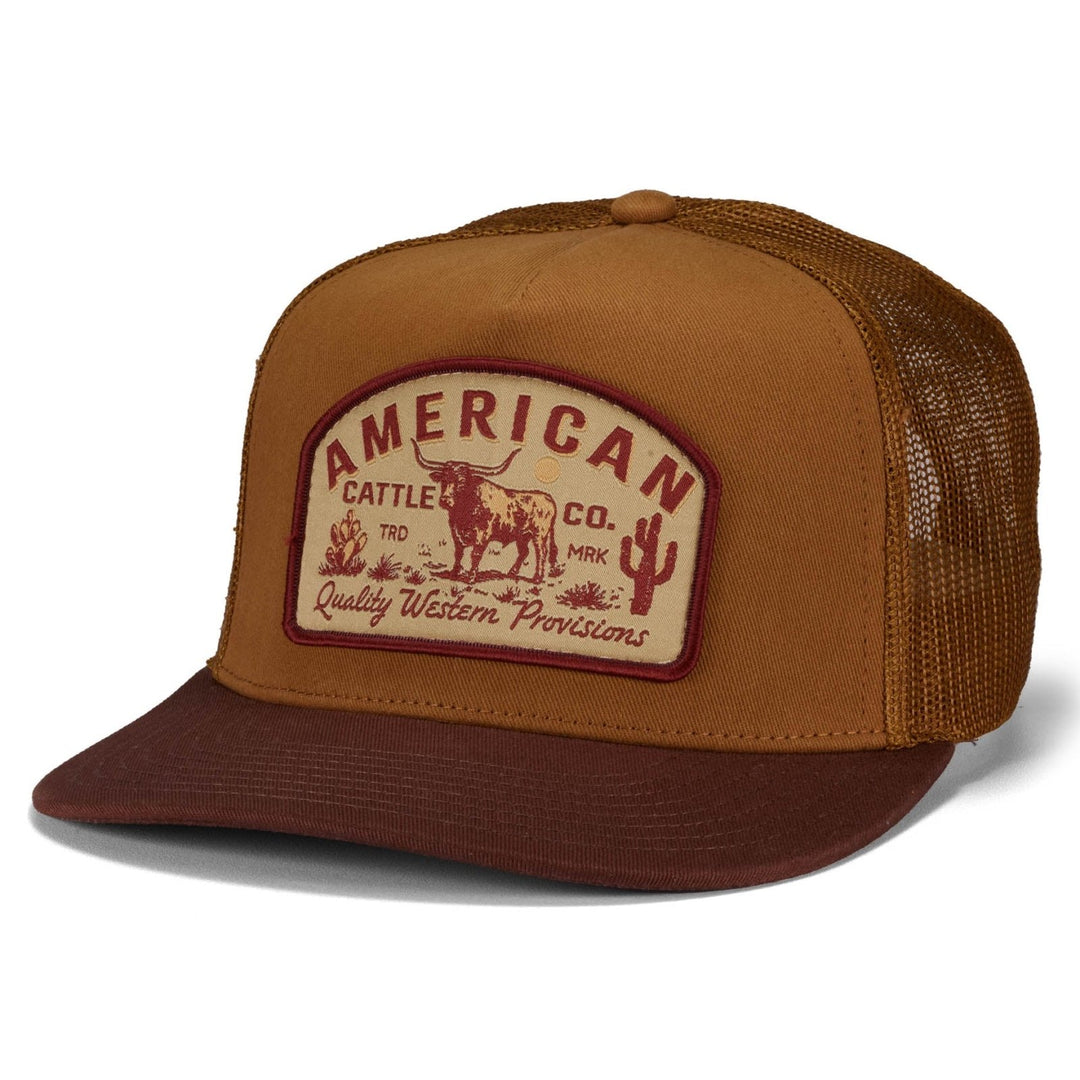 The American Cattle Co Provisions Hat is a brown and tan western style cap with a mesh back, featuring a front patch that says "American Cattle Co. Quality Western Provisions" with steer and cacti graphics plus an adjustable snapback.