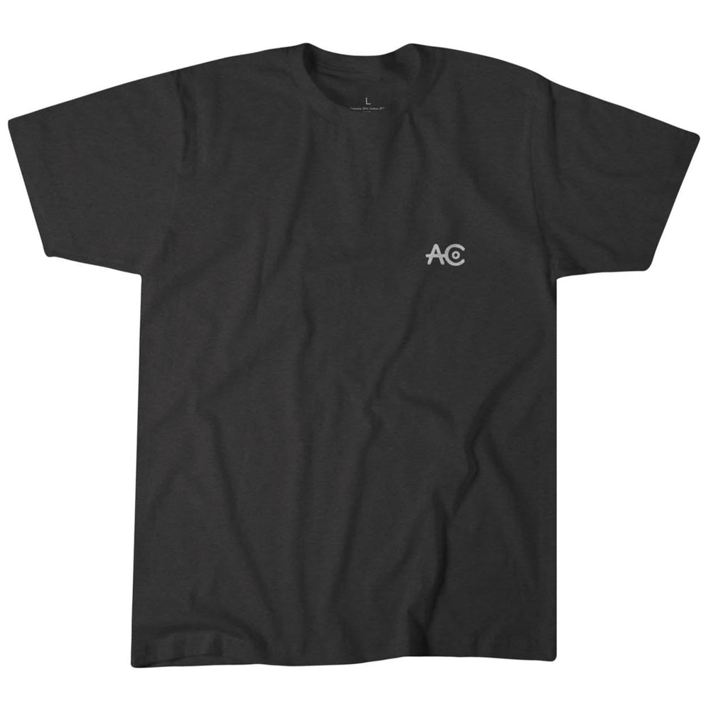 The Quality Goods Tee by American Cattle Co is a plain black t-shirt made from premium weight fabric, featuring a small white "AC" logo on the left chest. Inspired by American cattle ranchers and made in the USA, shown on a white background.