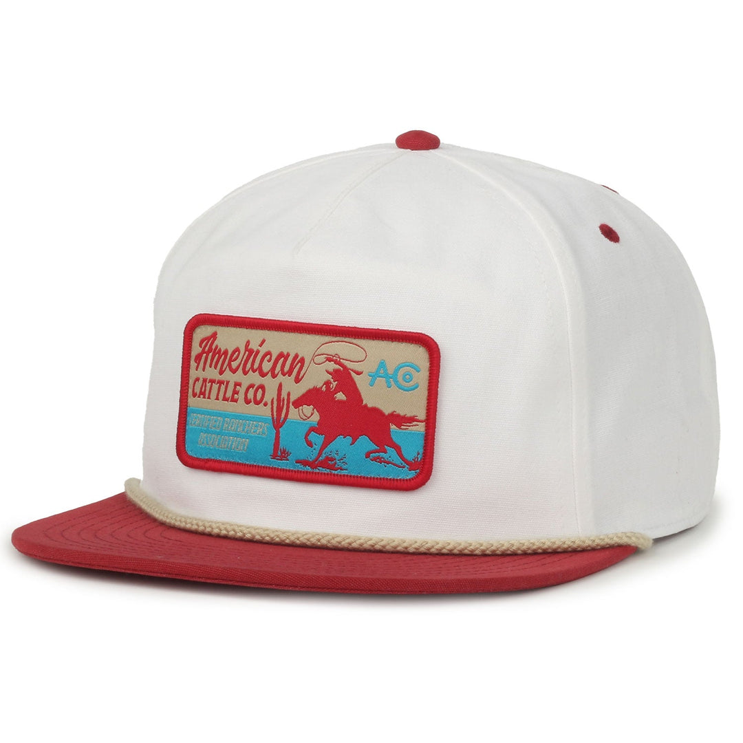 The Ranch Hand Hat by American Cattle Co is a white snapback cap with a red brim and button, featuring a front patch that displays "American Cattle Co." with a cowboy riding a bull and desert motifs—ideal for any hat collection.