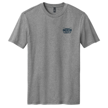 The American Cattle Co Range King Tee is a heather gray short-sleeve shirt with a small blue "American Road Trip" graphic on the left chest, shown laid flat on a white background.