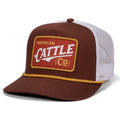 The Rural Cloth Red Label Hat is a brown and white mesh trucker hat with yellow brim trim, an adjustable snapback, and a bold red patch that reads 