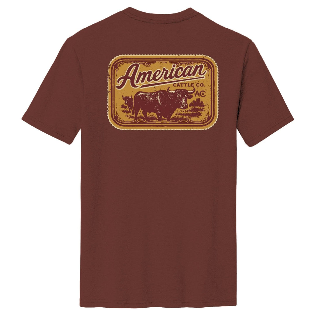 The Stockyard Tee by American Cattle Co is a classic fit maroon cotton shirt with a large back graphic: cow silhouette, “American Cattle Co.” text, and decorative borders.