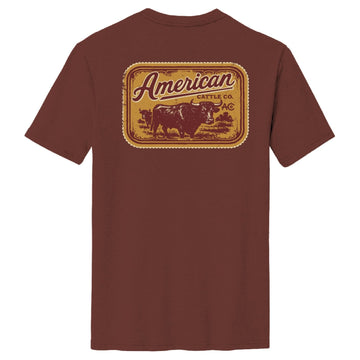 The Stockyard Tee by American Cattle Co is a classic fit maroon cotton shirt with a large back graphic: cow silhouette, “American Cattle Co.” text, and decorative borders.