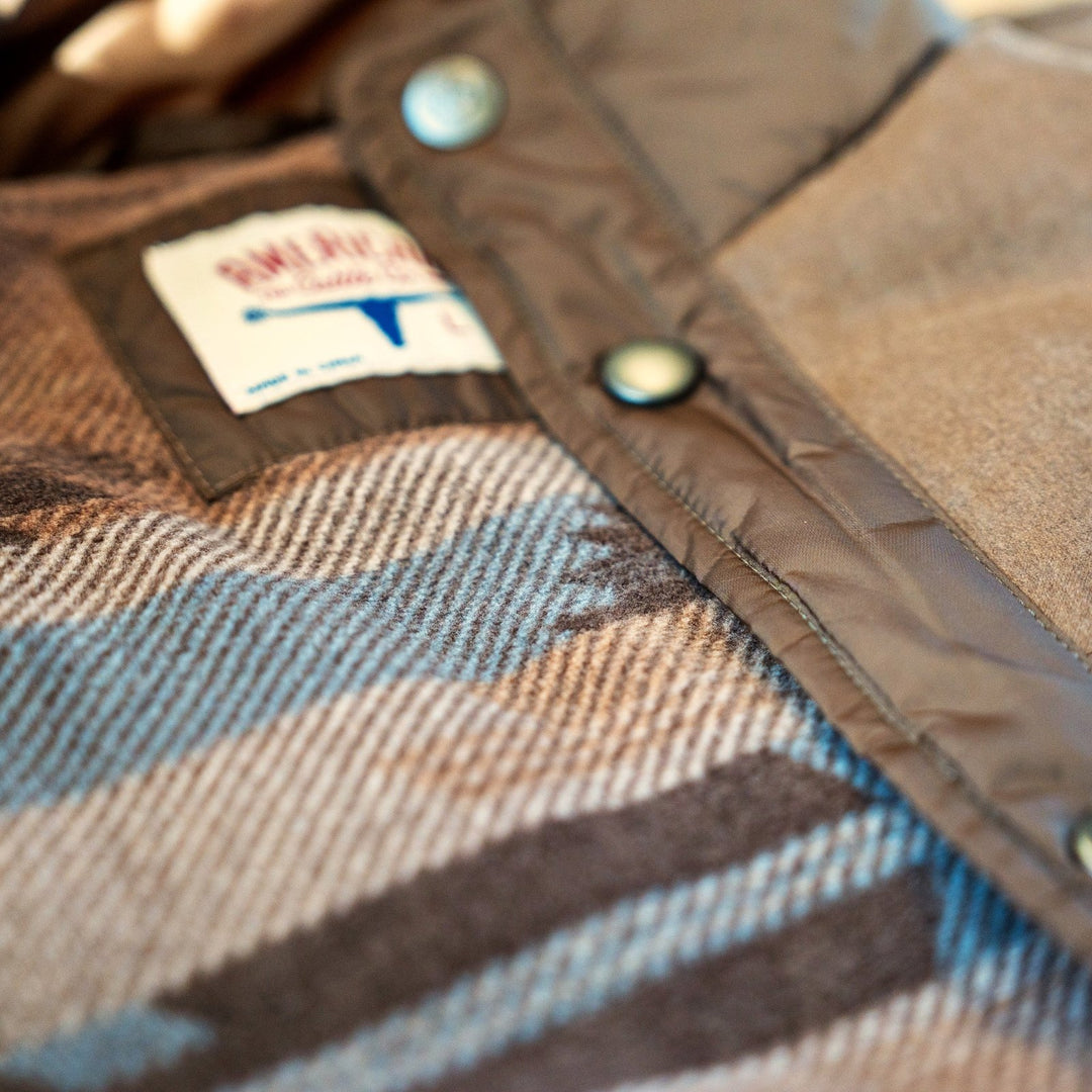 Inside The Cold Snap Puffer in Cocoa, showing the geometric-pattern lining, American Cattle Co label and snap placket.