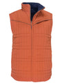 The Switchback Reversible Puffer by Rural Cloth is an orange quilted vest with a front zipper, high collar, western yoke, chest zip pocket, square-pattern stitching, and a dark blue interior lining.