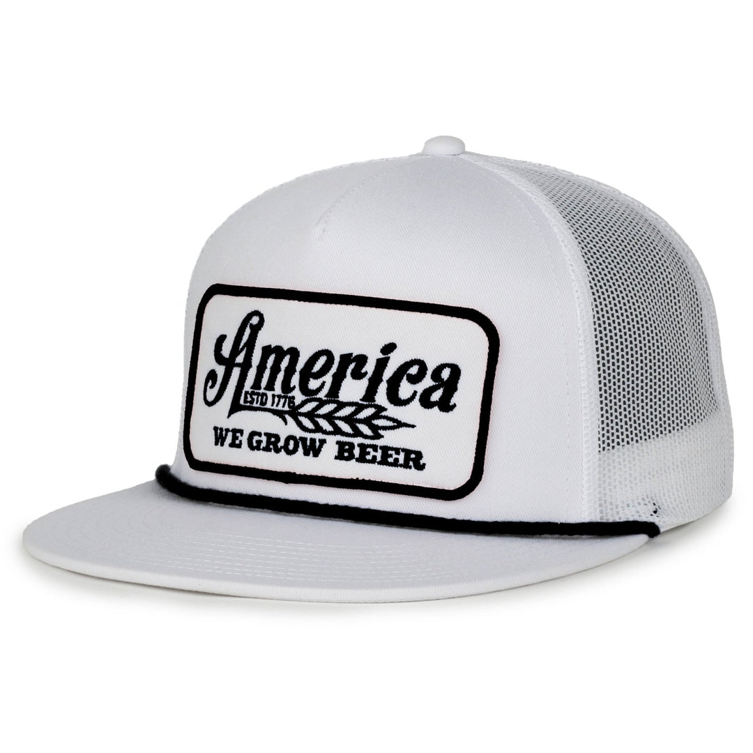 The American Cattle Co We Grow Beer Flat is a white mesh back snapback trucker hat with a flat bill and a front patch that says "America ESTD 1776 WE GROW BEER" in black, plus a wheat stalk graphic.