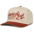 The Rural Cloth We Hunt Mallards Hat is a tan and burnt orange snapback baseball cap with “America We Hunt Since 1776” and a flying duck graphic on the front—ideal for anyone’s hunting hat collection.