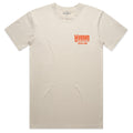 The American Cattle Co World Tour Tee is a premium cotton beige short-sleeve shirt featuring small orange 