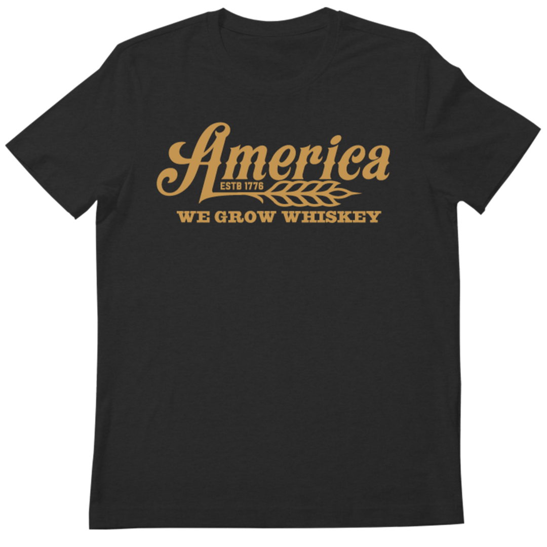 The 76 Wheat Tee-Black by Rural Cloth features bold yellow text on a black shirt, celebrating American heritage.