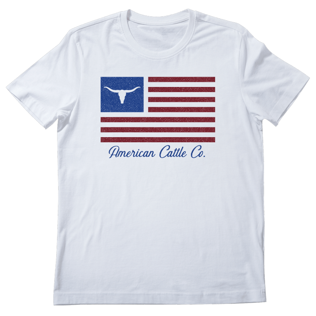The ACC Flag Tee by Rural Cloth is a white shirt featuring a stylized American flag with a longhorn silhouette in the blue field and "American Cattle Co." scripted below in blue.