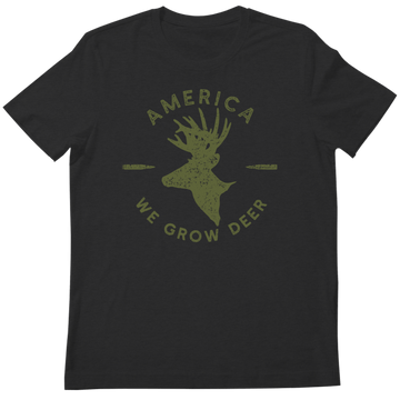The American Cattle Co We Grow Deer Tee-Black features a green deer head silhouette, two horizontal arrows, and "AMERICA WE GROW DEER" text—celebrating deer conservation and wildlife stewardship.